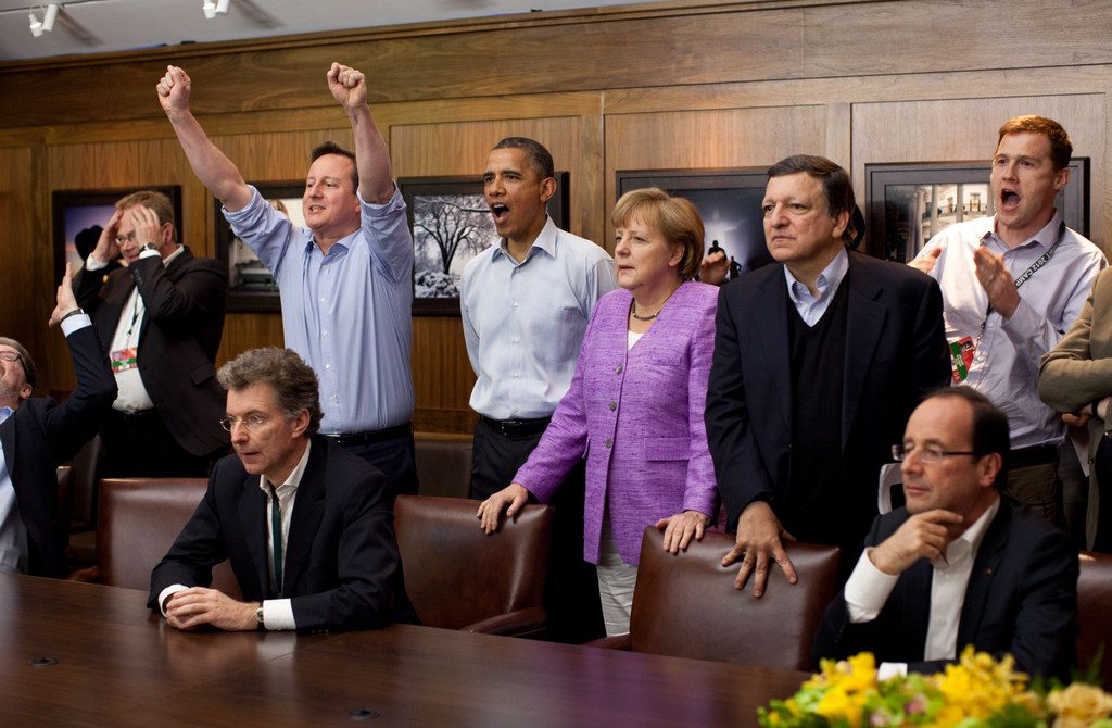 Prime Minister David Cameron of the United Kingdom, President Barack Obama, Chancellor Angela Merkel of Germany, JosЋ Manuel Barroso, President of the European Commission, and others watch the overtime shootout of the Chelsea vs. Bayern Munich Champions League final in the Laurel Cabin conference room during the G8 Summit at Camp David, Md., May 19, 2012. (Official White House Photo by Pete Souza) This official White House photograph is being made available only for publication by news organizations and/or for personal use printing by the subject(s) of the photograph. The photograph may not be manipulated in any way and may not be used in commercial or political materials, advertisements, emails, products, promotions that in any way suggests approval or endorsement of the President, the First Family, or the White House.